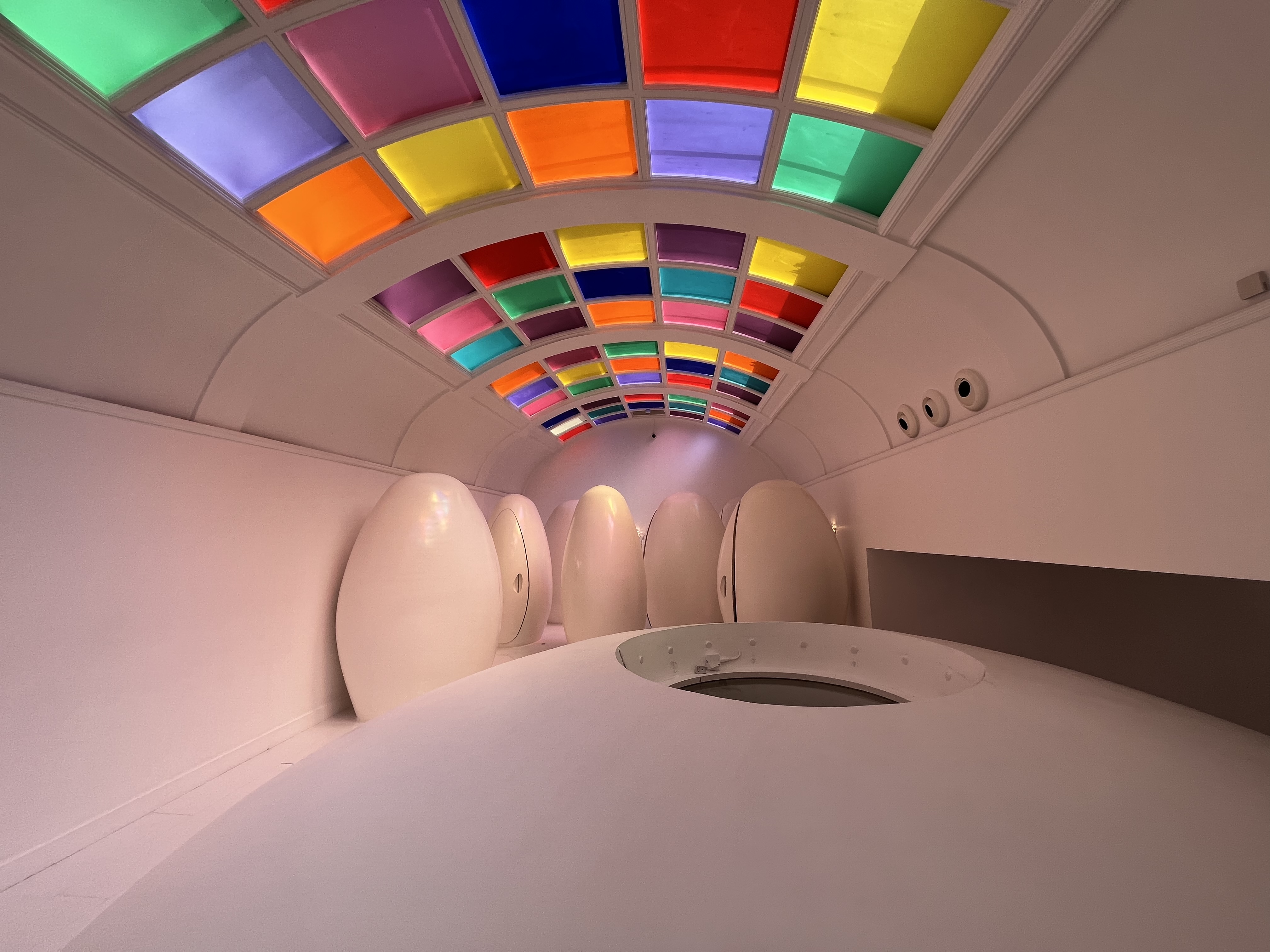 Colorful ceiling and egg-shaped toilet pods in the bathrooms at Sketch London